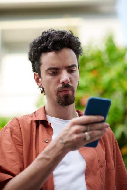 Frowning Man Reading Text Message