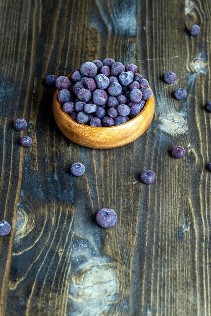 Frozen blueberries on a wooden table