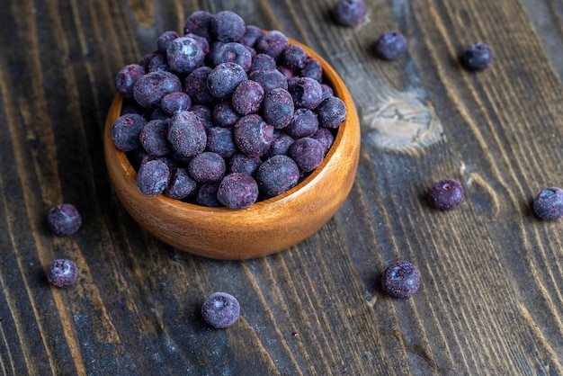 Frozen blueberries on a wooden table