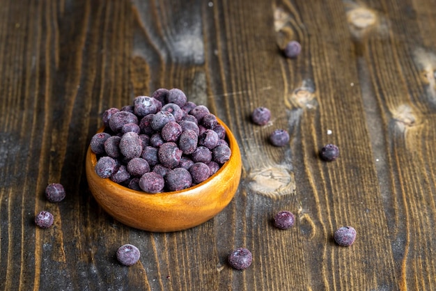 Frozen blueberries on a wooden table