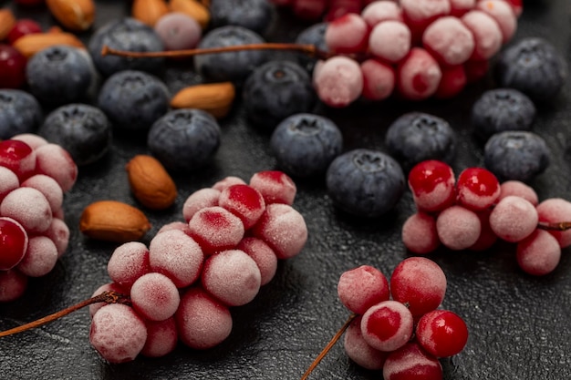 Frozen bunches of red berries and nuts