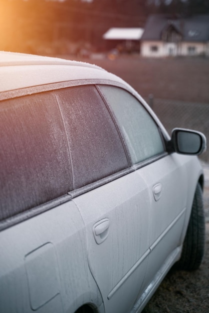 Frozen car on the outside parking Transport in winter Vehicle closeup with frozen windshield and windows