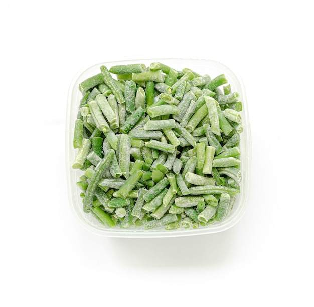 Frozen cut green beans in square plastic bowl on white background Top view Square format