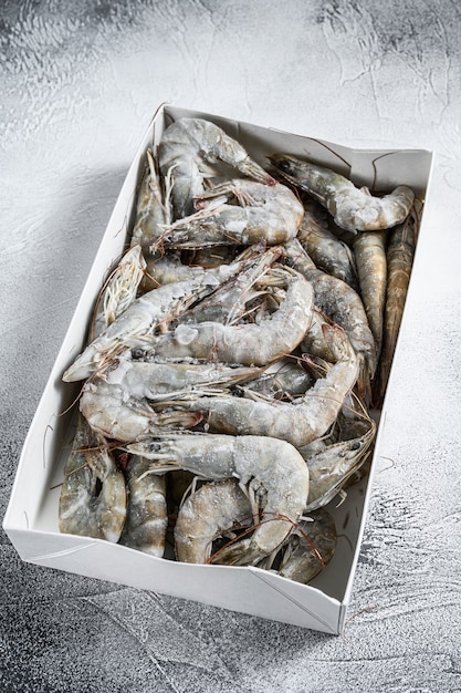 Frozen fresh big shrimps, prawns prepared for seafood cooking. White background. . 