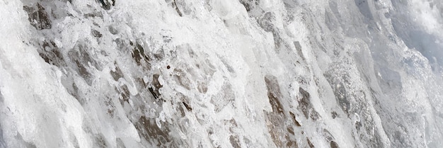 Frozen ice stalagmite in snow with ice in cave beauty and growth in the arctic mountains