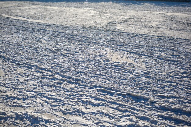 A frozen lake or river in winter Near the forest mountains in the snow Beautiful winter landscapes