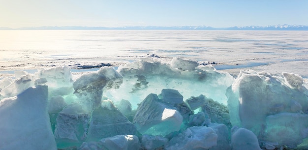 Frozen lake and snowy mountains winter landscape