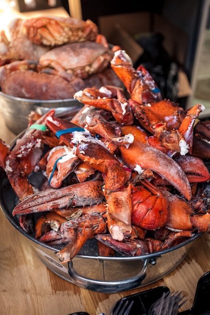 Frozen lobster claws at metal bucket at kitchen