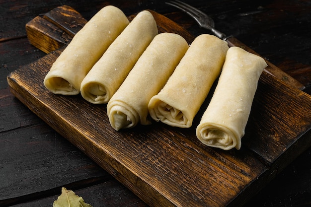 Frozen pancakes with meat on old dark wooden table background