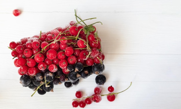 Frozen red and black currants in on a light background  The concept of preparing products for use in the future