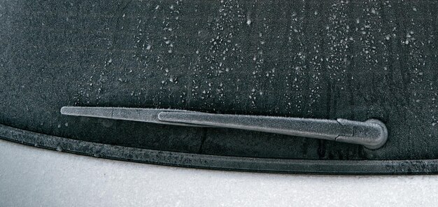 Frozen windshield wiper concept of dangerous driving during the winter season