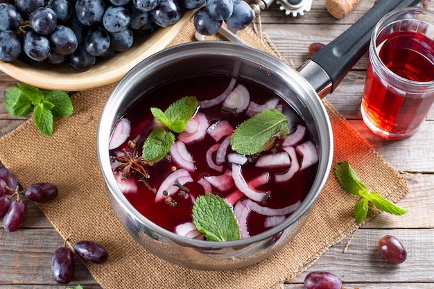 Frozen wine sauce in a stewpan on a wooden table.