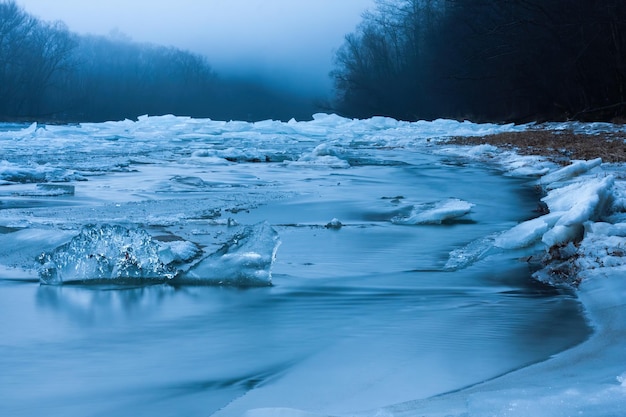 Frozen winter in unspoiled nature with ice on riverbanks