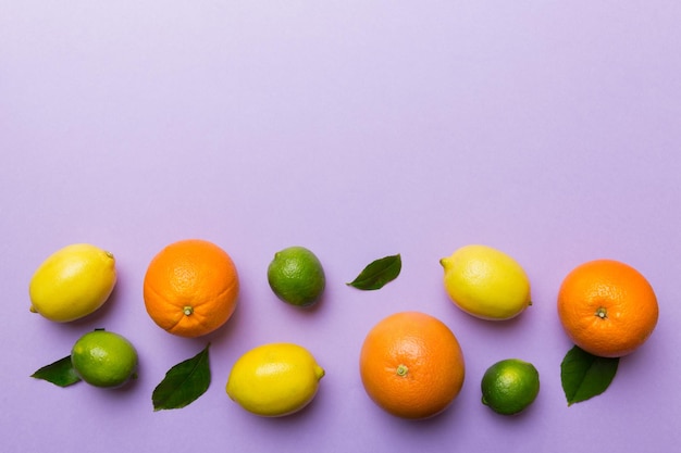 Fruit background Colorful fresh fruits on colored table Orange lemon grapefruit Space for text healthy concept Flat lay top view copy space