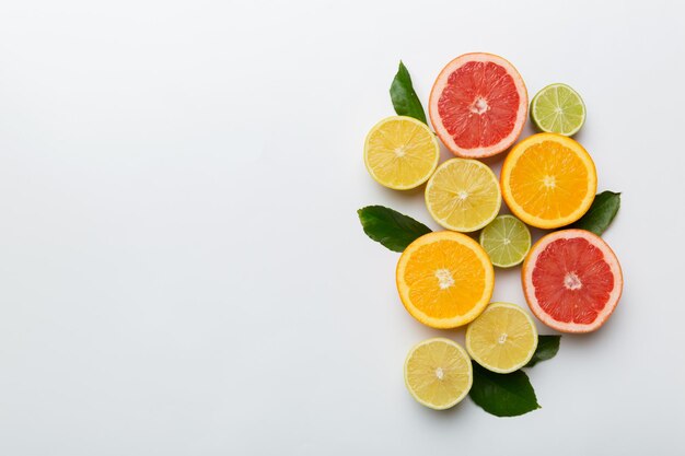 Fruit background Colorful fresh fruits on colored table Orange lemon grapefruit Space for text healthy concept Flat lay top view copy space