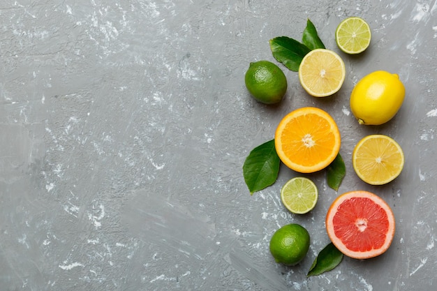 Fruit background Colorful fresh fruits on colored table Orange lemon grapefruit Space for text healthy concept Flat lay top view copy space