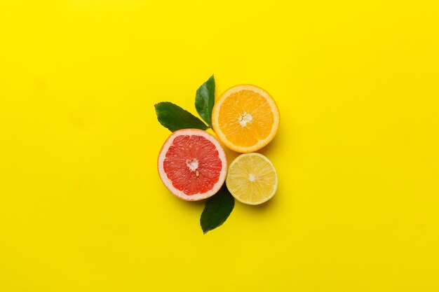 Fruit background Colorful fresh fruits on colored table Orange lemon grapefruit Space for text healthy concept Flat lay top view copy space