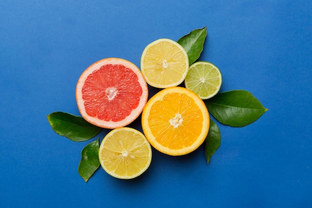 Fruit background Colorful fresh fruits on colored table Orange lemon grapefruit Space for text healthy concept Flat lay top view copy space