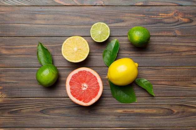 Fruit background Colorful fresh fruits on colored table Orange lemon grapefruit Space for text healthy concept Flat lay top view copy space