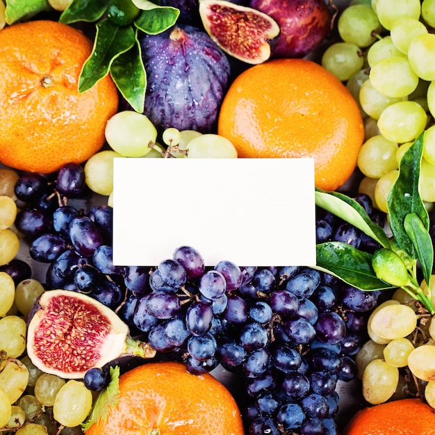 Fruit Background with Blank Business Card Grape Figs Plum and Tangerines Fruits