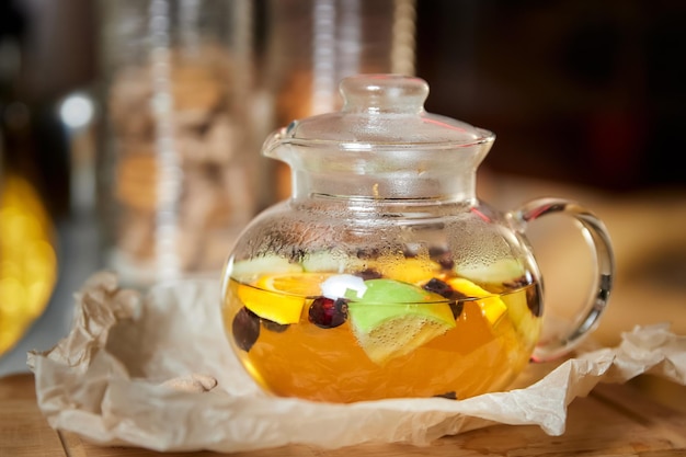 Fruit and berry tea in a transparent glass teapot