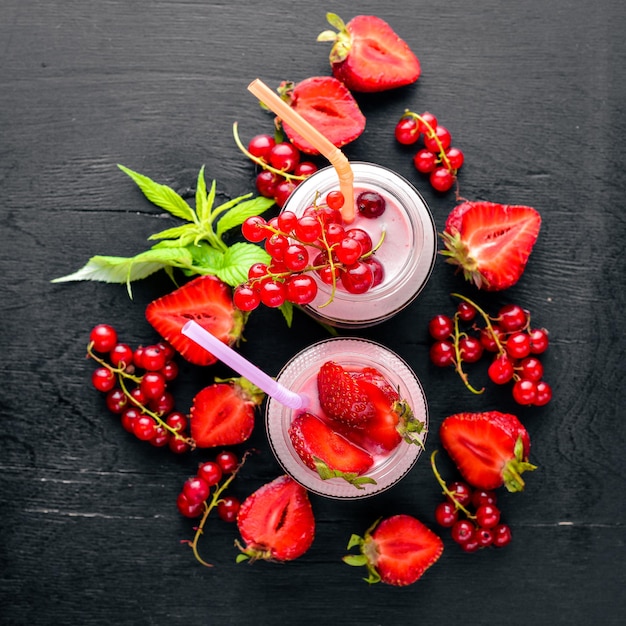 Fruit berry yoghurts and stripes On a wooden background Top review Free space