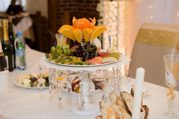 Fruit bowl on the wedding table Pears apples grapes kiwi