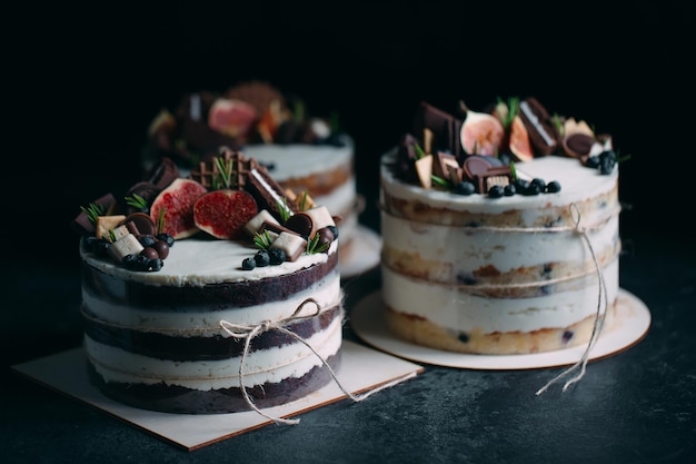 Fruit cake decorated with figs, cookies and blueberries.