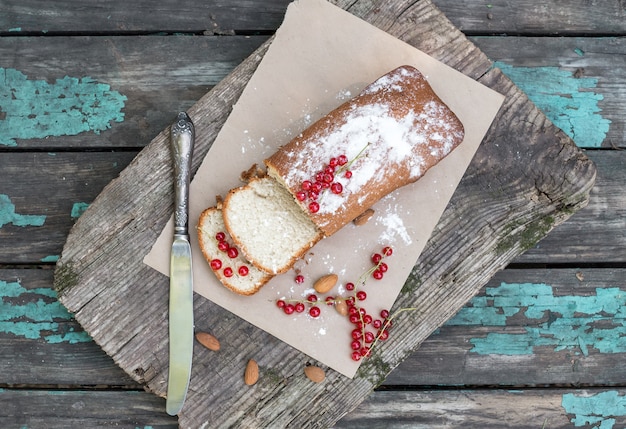 Fruit cake with red currant and almond on a garden table