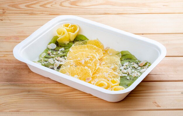 Fruit carpaccio made from tropical fruits Healthy food Takeaway food On a wooden background