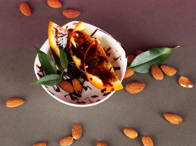 Fruit in chocolate against a gray background