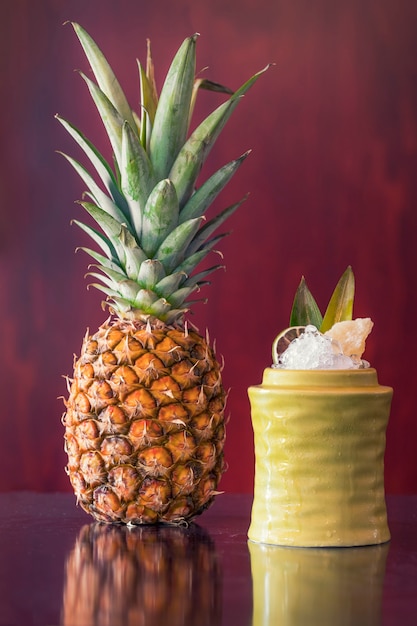 Fruit cocktail next to a pineapple