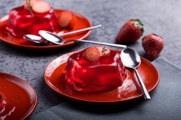 fruit jelly with fresh strawberry. Healthy food. Strawberry jelly on white plate. 