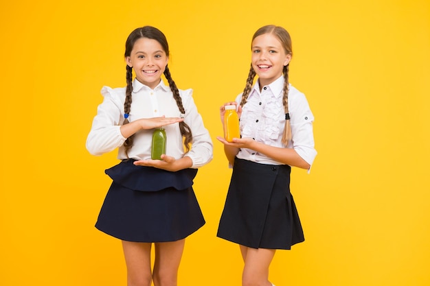 Fruit juice energy source School lunch Happy kids drink smoothie Healthy food Vitamin nutrition Fresh smoothie Girls kids drinking orange fruit fresh juice smoothie Schoolgirls having lunch