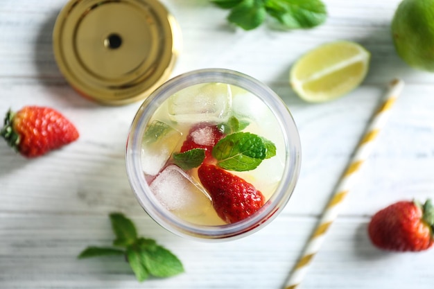 Fruit lemonade in mason jar on wooden table