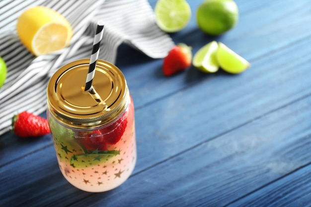 Fruit lemonade in mason jar on wooden table