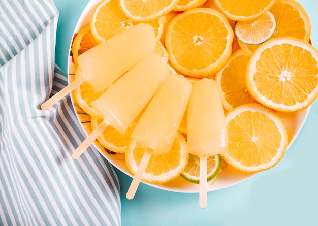 Fruit orange citrus popsicles ice pops and slices of orange Top view