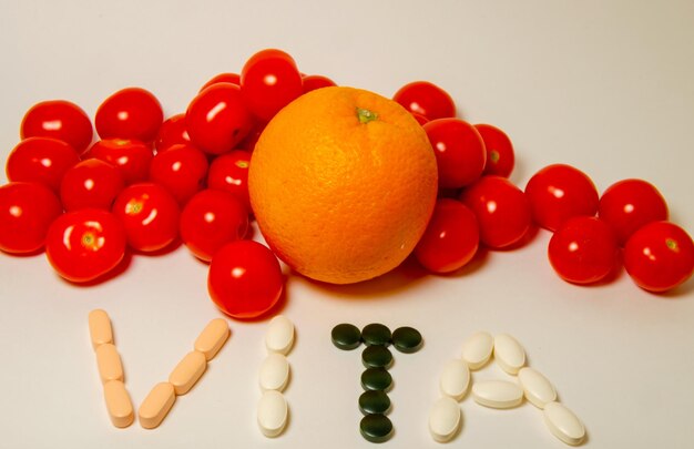 A fruit and a orange with the word " vitamin " on it