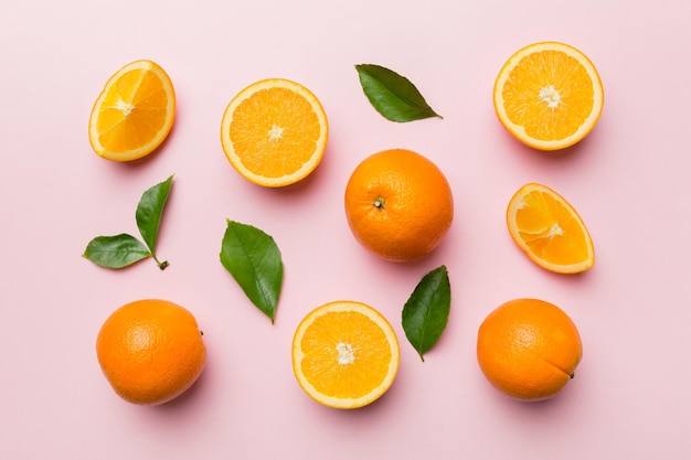 Fruit pattern of fresh orange slices on colored background Top view Copy Space creative summer concept Half of citrus in minimal flat lay