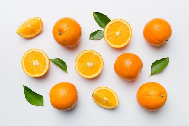 Fruit pattern of fresh orange slices on colored background Top view Copy Space creative summer concept Half of citrus in minimal flat lay