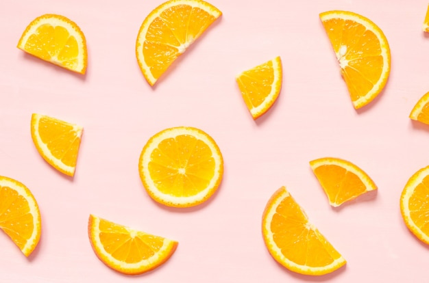 Fruit pattern of fresh orange slices on pastel background. Top view. 