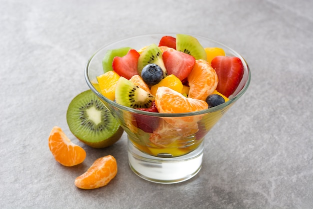 Fruit salad in crystal bowl on gray