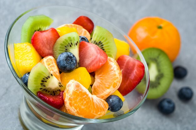 Fruit salad in crystal bowl on gray