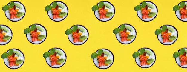 Fruit salad in the half coconut on the yellow background Flat lay Pattern