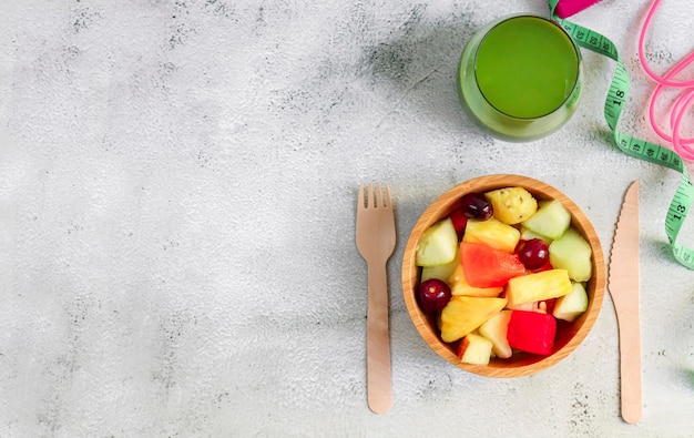 Fruit salad and smoothies on a concrete table