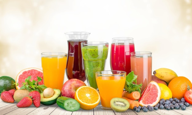 Fruit smoothies in glasses on wooden table