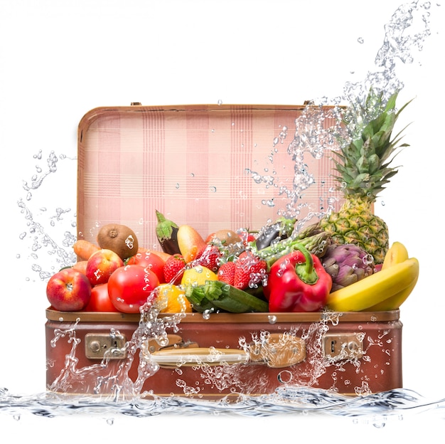 Fruit in suitcase falling in water