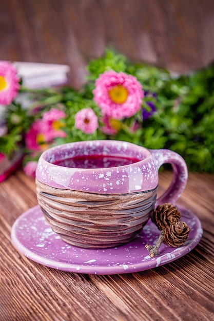 Fruit tea, books and flowers on a brown wooden background