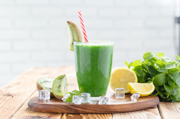 Fruit and vegetable green smoothie on a wooden table