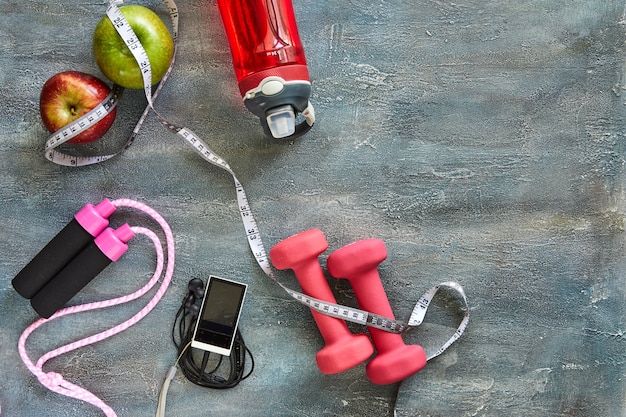 Fruits, dumbbells, a bottle of water, rope, meter, player on blue 